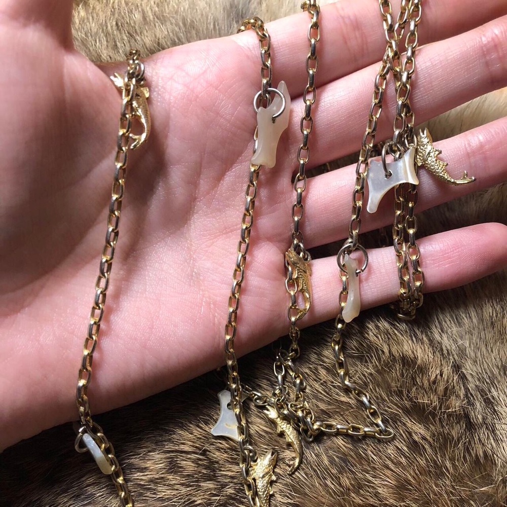 Vintage gold toned chain necklace with fish and mother of pearl charms